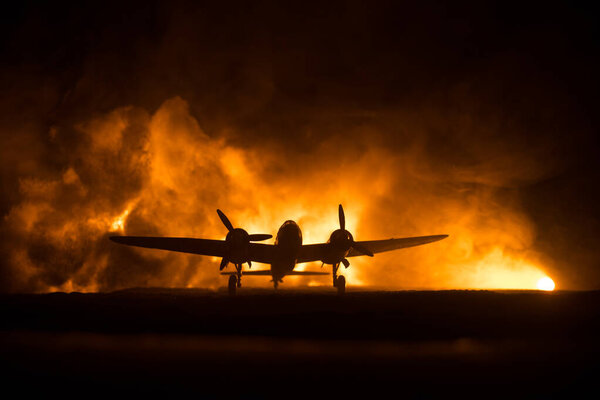 German Junker (Ju-88) night bomber at night. Artwork decoration with scale model of jet-propelled plane in possession. Toned foggy background with light. War scene. Selective focus