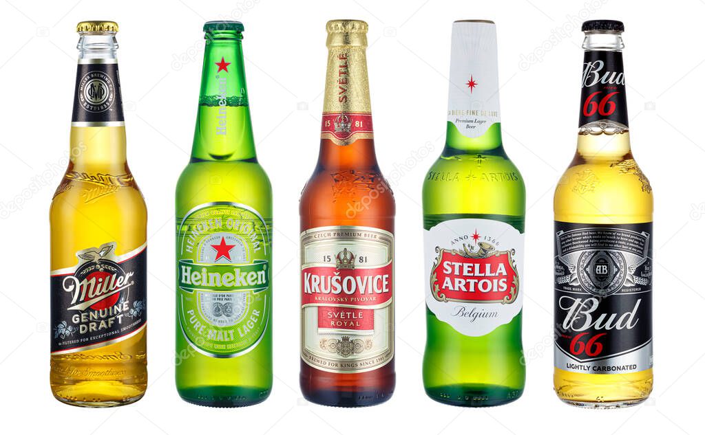 Moscow, Russia - April 14, 2021: Five glass bottles of different beer in a row close-up isolated on white background