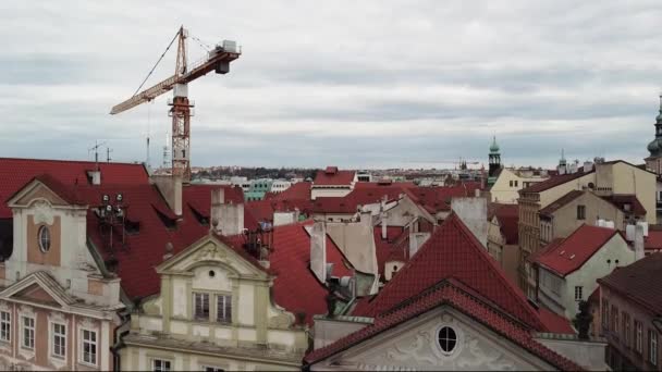 Construction crane in middle of historical city area with old beautiful architecture. Construction equipment. Aerial view. — Stock Video