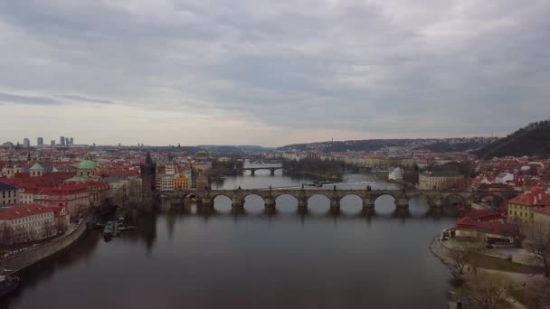 Aerial view of Prague Charles Bridge over Vltava river at cloudly sunset. Old Town of Prague, Czech Republic. — Stock Video