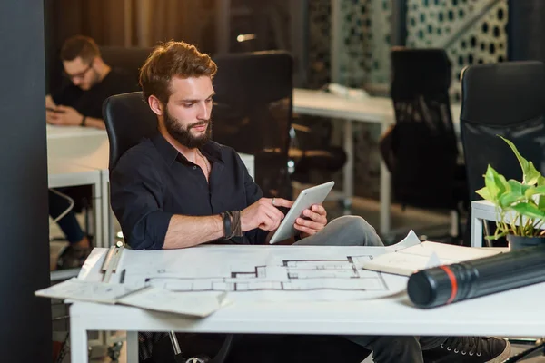 Young bearded architect working with scratches on his new project. — Stock Photo, Image