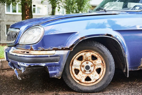 old rusty blue car, front view, day