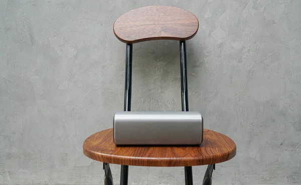 portable speaker on wooden chair for music connection with loft wall background