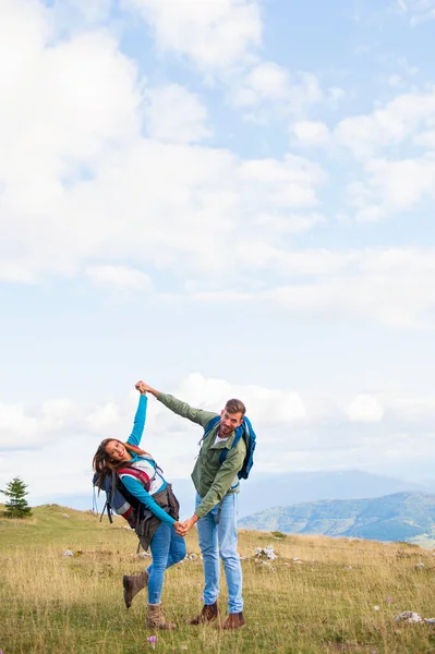 Heureux couple de voyageurs conquis sommet de la montagne, lève la main vers le haut — Photo