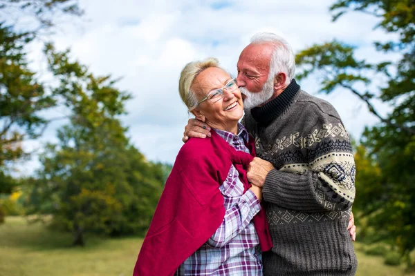 Senior couple on a walk in an autumn nature.