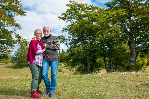 Senior couple on a walk in an autumn nature.