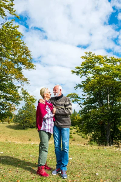 Senior couple on a walk in an autumn nature.