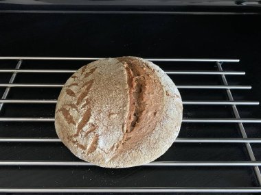 Artisan sourdough bread on the grill top view, beautiful drawing on the bread