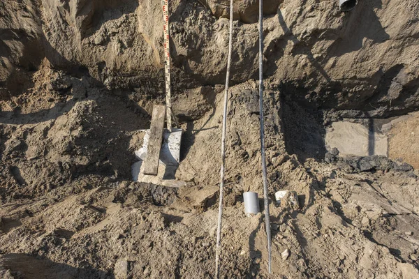 Plastic pipes in the ground during the construction of a building, bunner with copy space