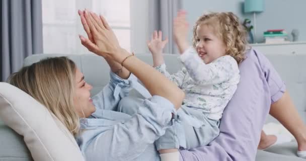 Middle plan of adorable infant kid girl playing patty cake with mom at home. Happy family mother and cute little daughter learning funny game, having fun, enjoying sweet moments together. — Stok video