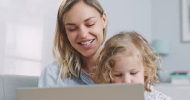 Close up of nanny and cute kid make distant online call to mother looking at camera talking at webcam, babysitter with child girl laughing communicate online in internet video chat