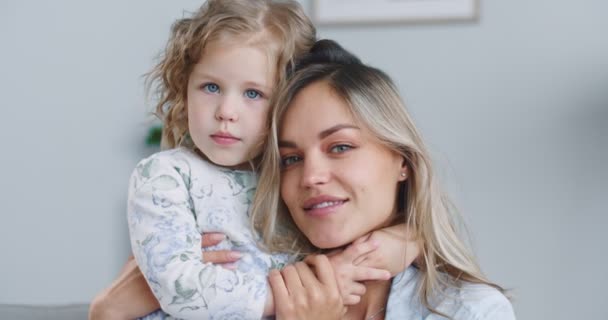 Close up of happy cute affectionate adopted little kid girl hugging foster care mother and smiling, adorable small child daughter embrace mum cuddling enjoy tender sweet moment. — Vídeos de Stock