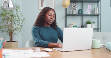 Genç, güzel, yorgun Afrikalı Amerikalı kız masada oturuyor ve evdeki bilgisayarda interneti arıyor. Yorgun yüzle çok çalıştıktan sonra bilgisayarını kapatan bir kadının portresi. Çalışma konsepti