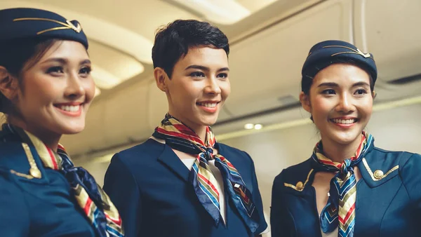 Group of cabin crew or air hostess in airplane — Stock Photo, Image