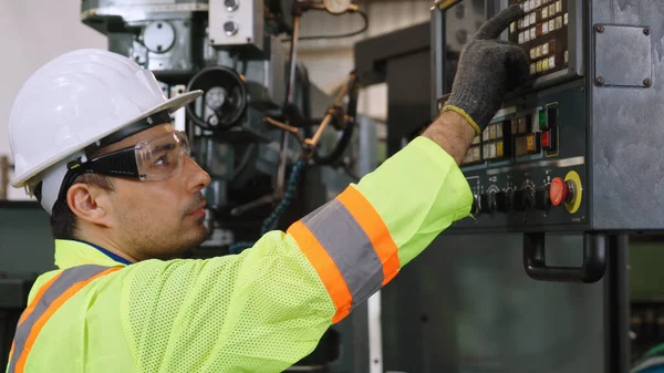 Smart factory worker using machine in factory workshop