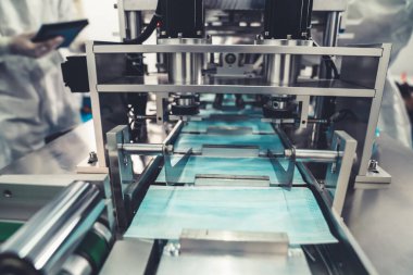 Modern fabrikada yüz maskesi üretim hattı