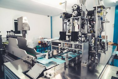 Modern fabrikada yüz maskesi üretim hattı