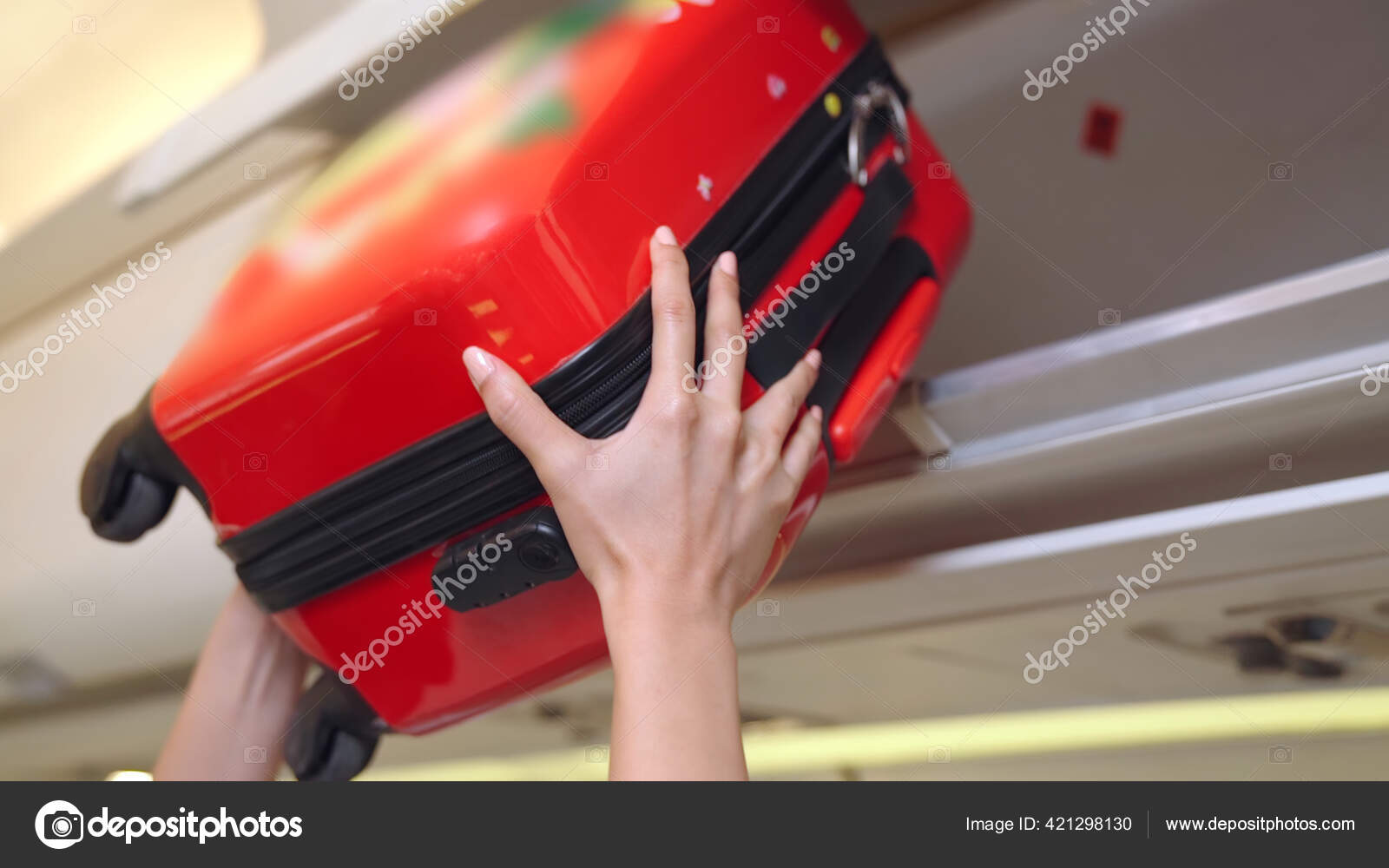 Cabin crew lift luggage bag in airplane Stock Photo by ©BiancoBlue 421298130