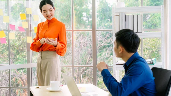 Business people work on project planning board