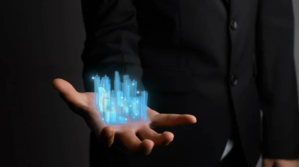 Businessman holds 3D city model showing augmented reality technology — Stock Photo, Image