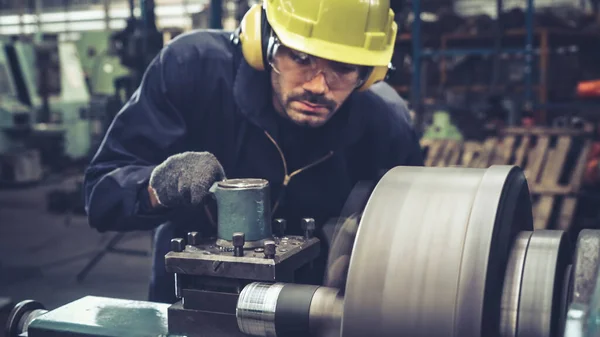 Smart factory worker using machine in factory workshop