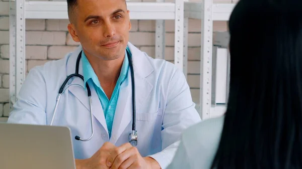 Doctor in professional uniform examining patient at hospital