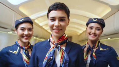 Bir grup kabin görevlisi ya da hostes uçakta.