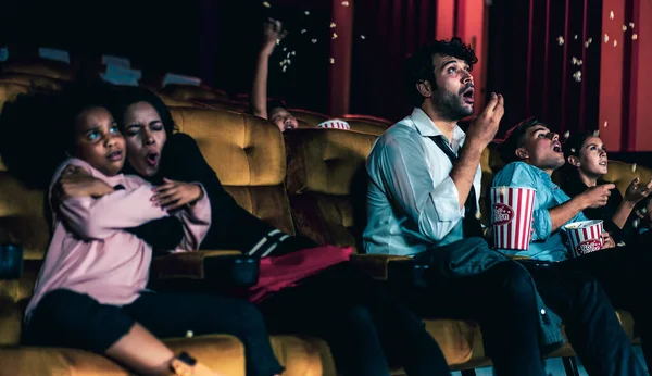 Shocked audience watching a horror movie — Stock Photo, Image