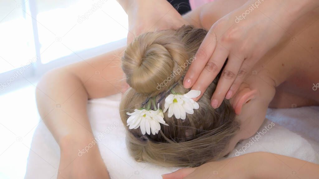 Woman gets neck and head massage and in luxury spa