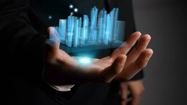 İşadamı gelişmiş gerçeklik teknolojisini gösteren 3D şehir modelini elinde tutuyor