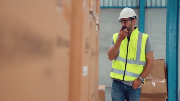 Trabajador de carga profesional habla por radio portátil para contactar a otro trabajador — Vídeos de Stock