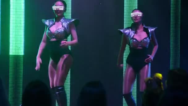 Grupo de personas bailan en discoteca al ritmo de la música de DJ en el escenario — Vídeos de Stock