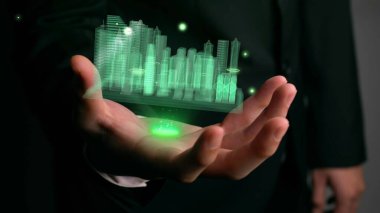 İşadamı gelişmiş gerçeklik teknolojisini gösteren 3D şehir modelini elinde tutuyor