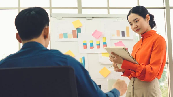 Young woman explains business data on white board — Stock Photo, Image