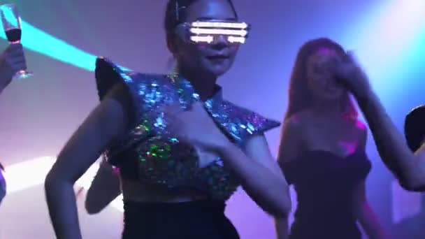 Groep mensen dansen in disco nachtclub op de beat van muziek van DJ op het podium — Stockvideo