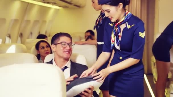 Cabin crew give service to passenger in airplane — Stock Video