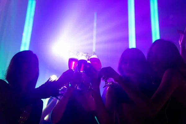 Silhouette image of people dance in disco night club to music from DJ on stage — Stock Photo, Image