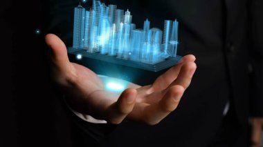 İşadamı gelişmiş gerçeklik teknolojisini gösteren 3D şehir modelini elinde tutuyor