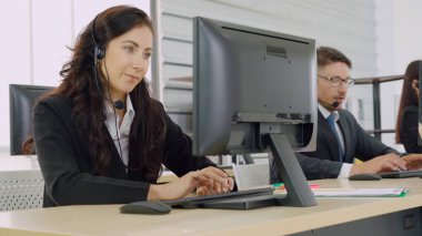 Ofiste çalışan kulaklık takan iş adamları.