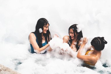 Eğlence ve neşeyle kabarcık havuzunda oynayan kız