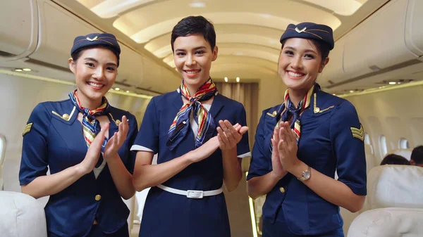 Group of cabin crew or air hostess in airplane — Stock Photo, Image