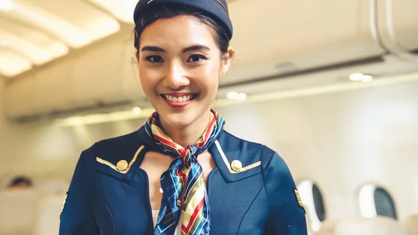 Cabin crew or air hostess working in airplane — Stock Photo, Image