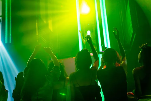 Silhouette kép az emberek táncolnak disco night club zenét DJ a színpadon — Stock Fotó