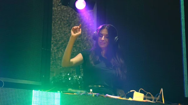 DJ op het podium in disco nachtclub mengen techno muziek beat — Stockfoto
