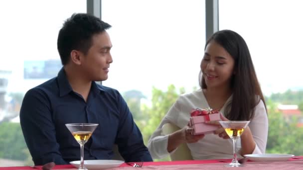 Romantyczna para daje prezent kochankowi w restauracji — Wideo stockowe