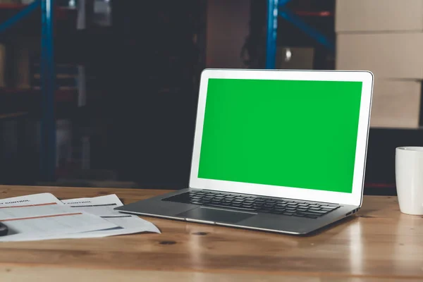 Computer with green screen display in warehouse storage room — Stock Photo, Image