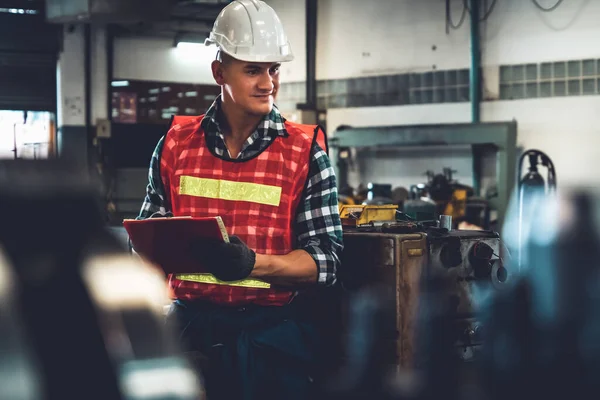 Trabajador de fabricación que trabaja con portapapeles para hacer la lista de verificación del procedimiento de trabajo . —  Fotos de Stock