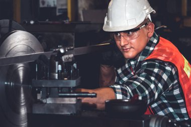 Akıllı fabrika işçisi veya mühendisi bir imalat atölyesinde makine işi yapıyor.