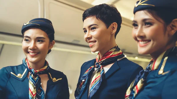 Group of cabin crew or air hostess in airplane