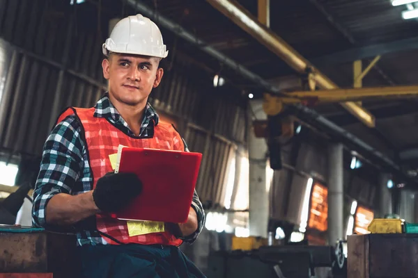 Trabalhador de fabricação que trabalha com área de transferência para fazer a lista de verificação do procedimento de trabalho . — Fotografia de Stock